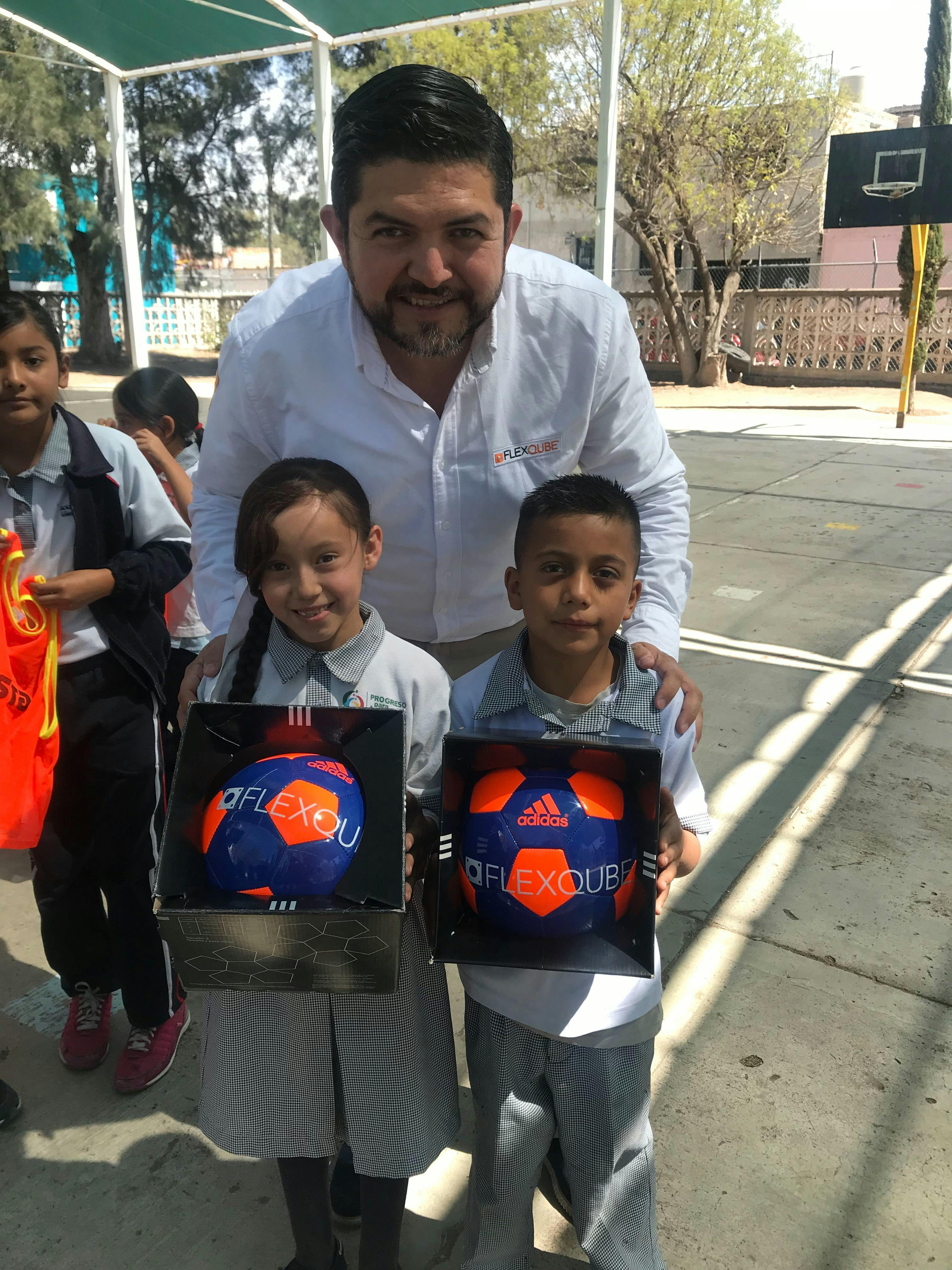 FlexQube Mexico Sales Manager Hector Flores giving our footballs to children in Mexico